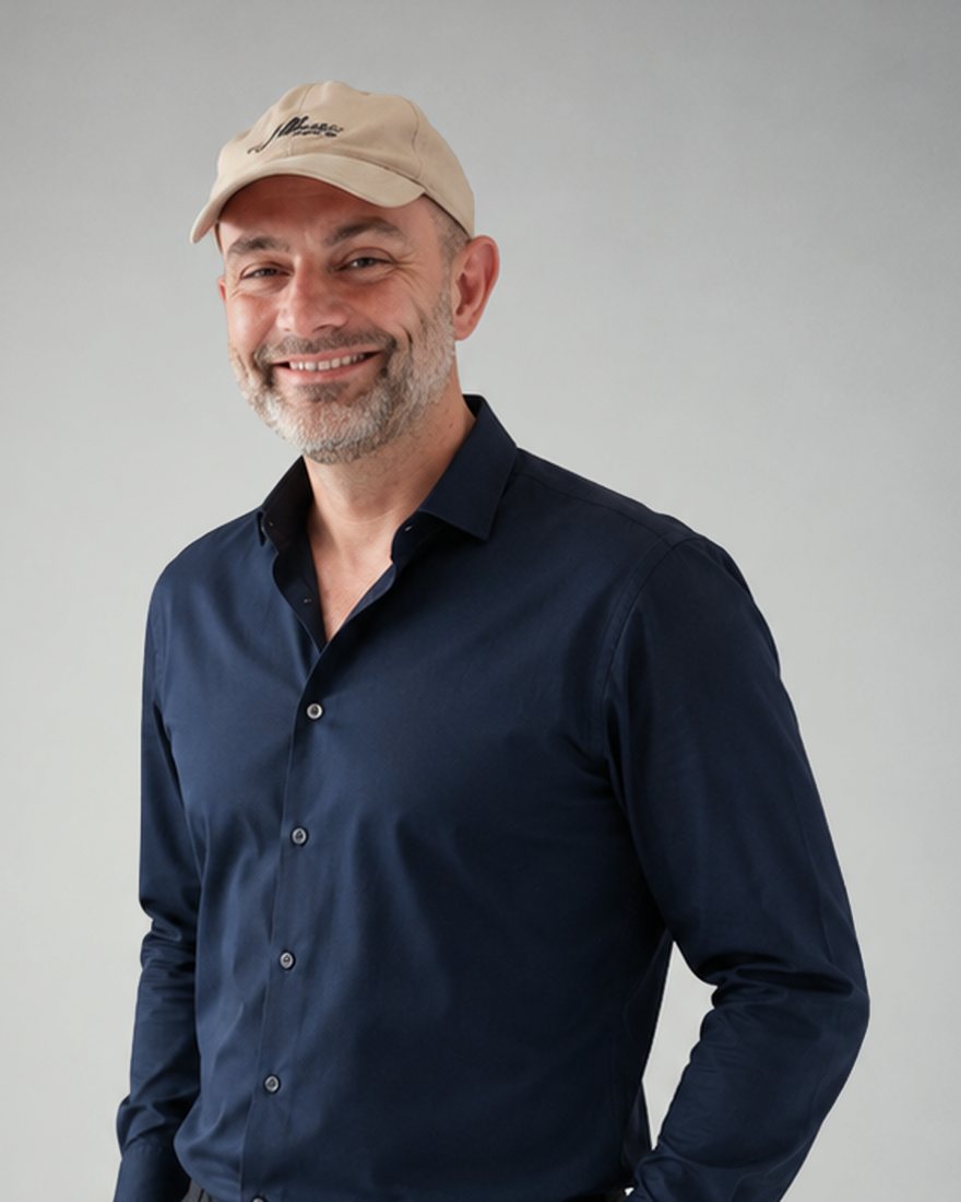 Vince Hruby, hands in pockets, navy shirt and a cap.